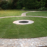 Bradstone graphite paving surrounding grass area and water feature