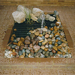 Small rectangular pond fountain with safety grill
